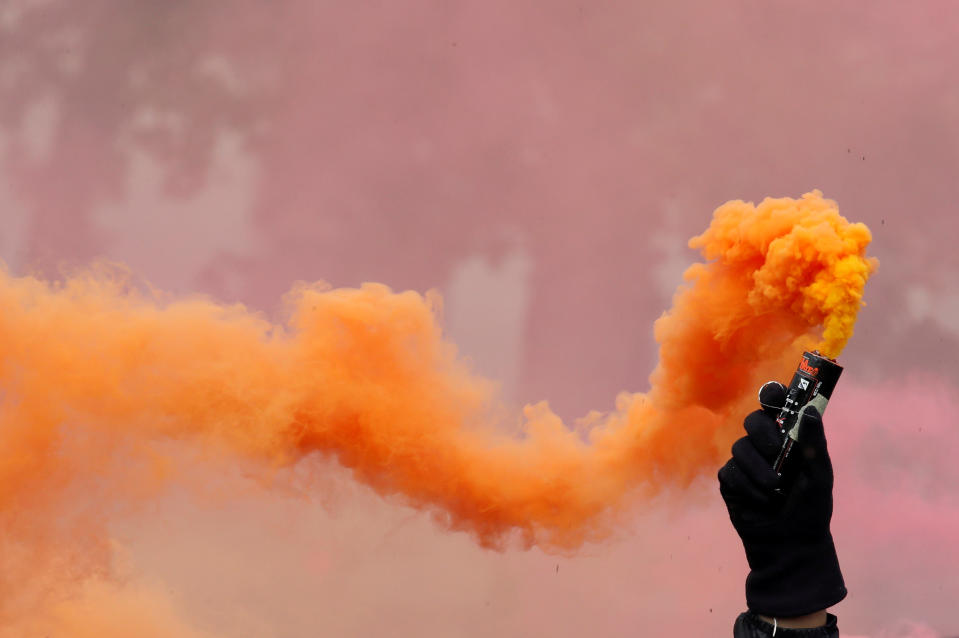 <p>A protester holds a smoke safety flare during the May Day labor union march in Paris, France, May 1, 2018. (Photo: Christian Hartmann/Reuters) </p>