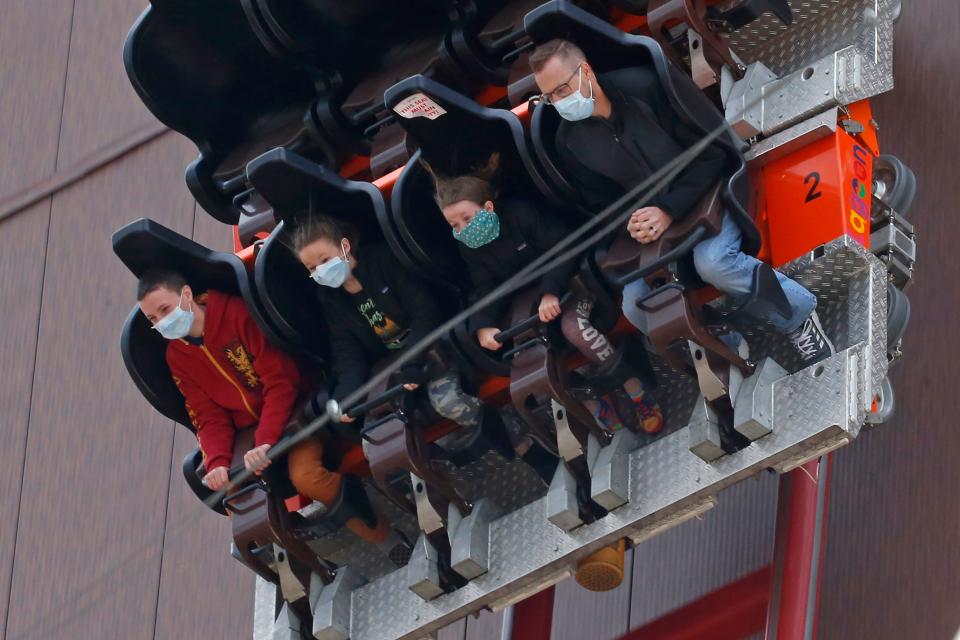 People ride the Cannibal at Lagoon Amusement Park in Farmington, Utah, on May<TH>23. The state is seeing a spike in new COVID-19 cases about a month after many businesses were allowed to reopen.