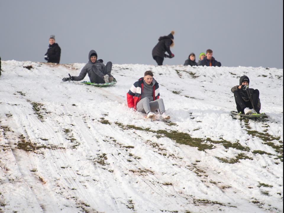 <p>Sledging on Wychbury Hill in Hagley, Worcestershire</p> (PA)