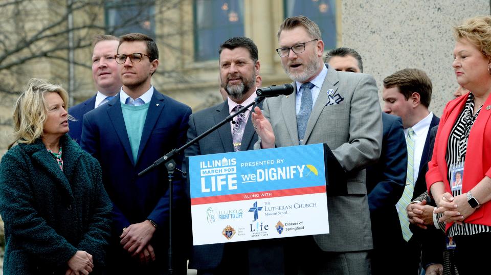 State Rep. Bill Hauter R-Morton, center right, speaks while flanked by other Republican representatives during the Illinois March for Life rally at the State capitol Tuesday, March 21, 2023.