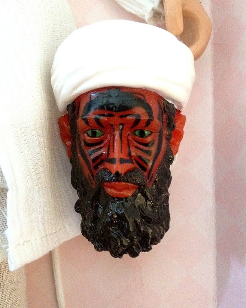 Decorative mask with a bearded face and white headgear