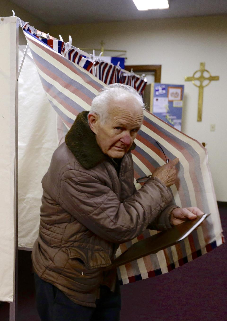 Rudy Humlicek exits the polling booth in Fremont, Neb., Tuesday, Feb. 11, 2014. Fremont voters are voting on whether to scrap the city's housing restrictions that were supposed to make it hard for people living in the country illegally to live there. This new vote on the ordinance voters approved in 2010 was scheduled because city leaders are worried about possibly losing federal grants and racking up big legal bills defending the law. (AP Photo/Nati Harnik)