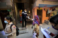 Health workers conduct a door to door survey to assess the COVID-19 situation in New Delhi, India, Monday, Nov. 23, 2020. India has more than 9 million cases of coronavirus, second behind the United States. (AP Photo/Manish Swarup)