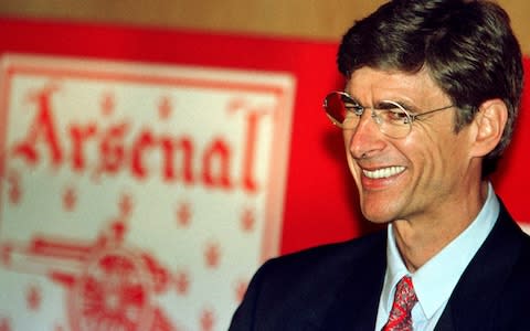 Arsene Wenger smiles during a press conference after becoming manager of Arsenal - Credit: reuters