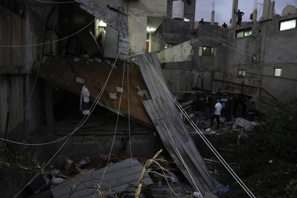 Palestinians inspect a damaged building following an Israeli army raid in Nour Shams refugee camp in the northern West Bank, Sunday, Sept. 24, 2022. Palestinians said at least two people were killed in the raid, which the army said was carried out to destroy a militant command center and bomb-storage facility in the building. (AP Photo/Majdi Mohammed)