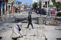 <p>A man balances a TV monitor on his head as he walks through roadblocks set up by anti-government protesters during a general strike in Port-au-Prince, Haiti, Monday, July 9, 2018. (Photo: Dieu Nalio Chery/AP) </p>