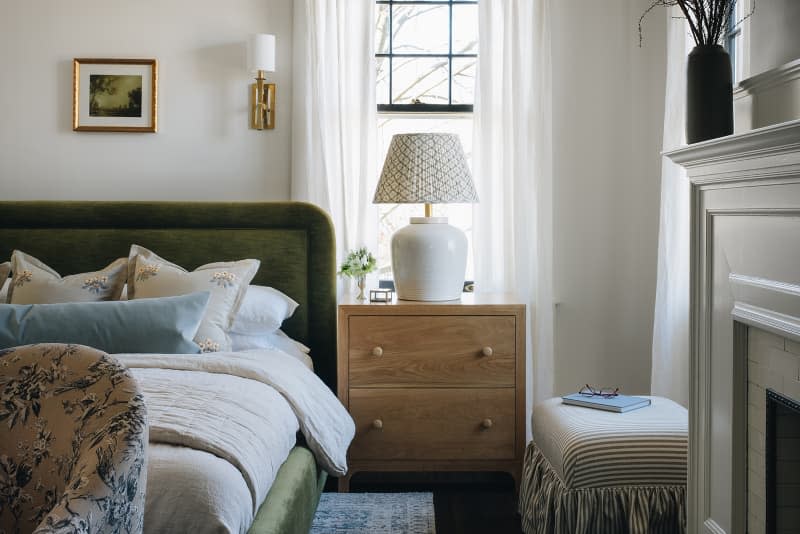 Lamp on side table in cozy bedroom.