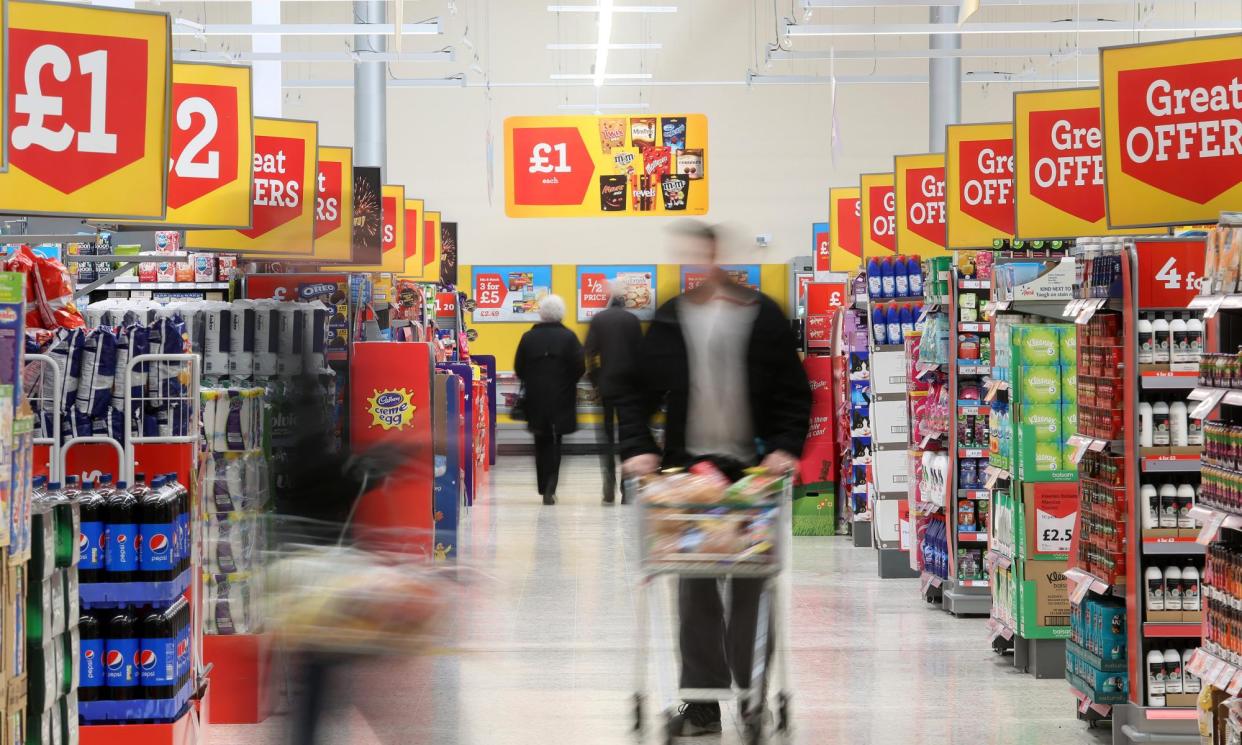 <span>Shoppers in a Morrison’s supermarket. The chain has launched a price match scheme with Aldi and Lidl, after Asda made the move in January.</span><span>Photograph: Bloomberg/Getty Images</span>