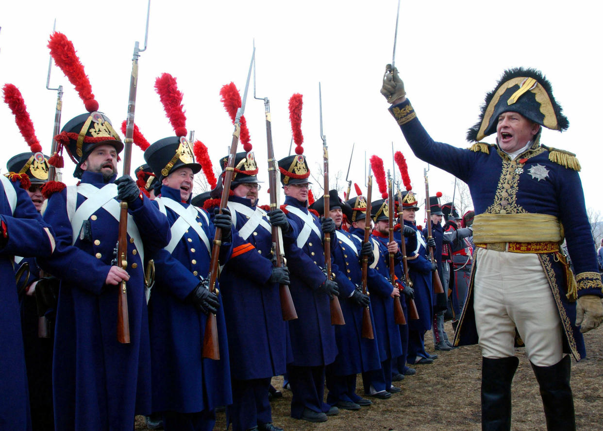 Oleg Sokolov (R), president of the military-historical association of Russia who is dressed as French emperor Napoleon Bonaparte, welcomes members of the Krasnoyarsk society of fans of the military history sporting the uniforms of French naval gunners during a show in a park in the Siberian city of Krasnoyarsk, April 10, 2005. The members of the clubs from major Siberian cities - Krasnoyarsk, [Novosibirsk, Tomsk and Irkutsk], took part on Sunday in the first Siberian regional festival of clubs of military-historical reconstruction.