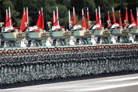 Soldiers react as Chinese President Xi Jinping (unseen) inspects troops at the People's Liberation Army (PLA) Hong Kong Garrison as part of events marking the 20th anniversary of the city's handover from British to Chinese rule, in Hong Kong, China June 30, 2017. REUTERS/Damir Sagolj