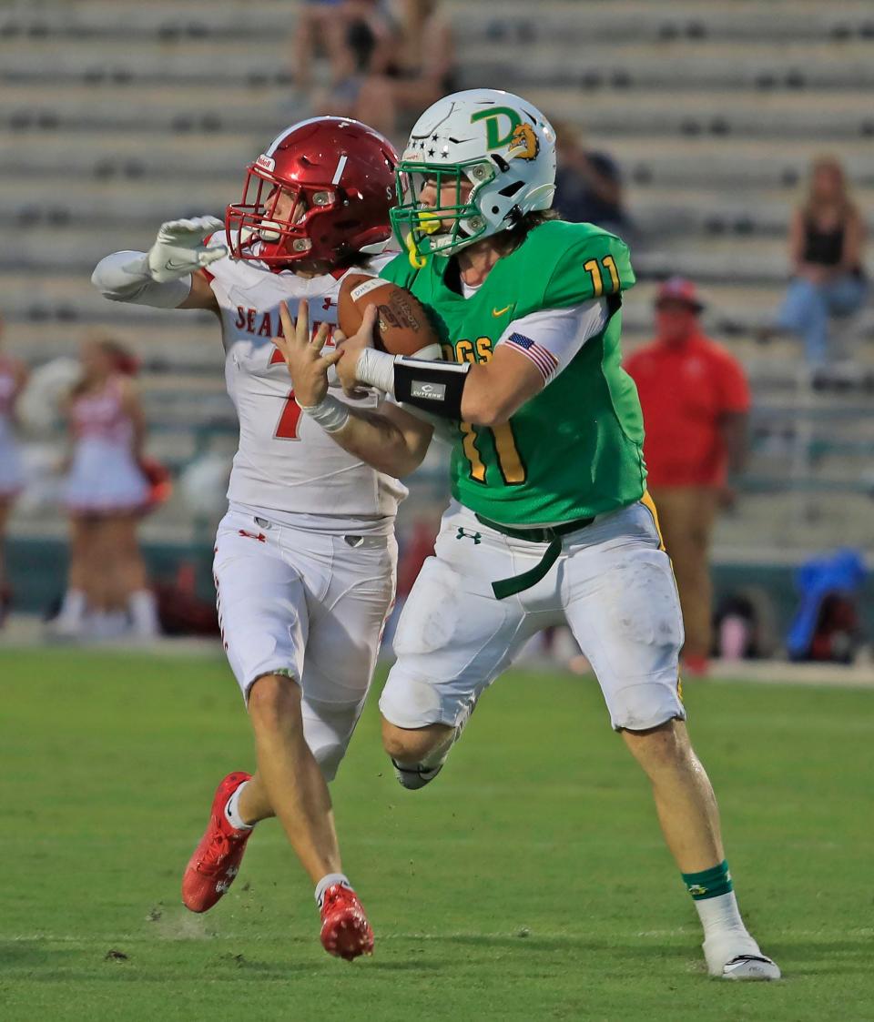 DeLand's Wyatt Darlington (11) catches the ball with a Seabreeze defender right on him, Friday, Sept. 22, 2023.