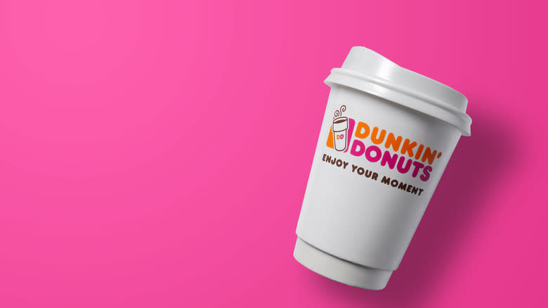 Dunkin' hot cup on pink