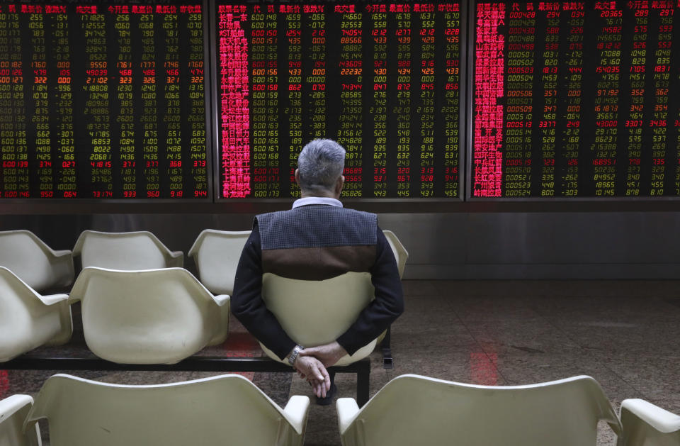 An investor monitors stock prices at a brokerage in Beijing Tuesday, Nov. 20, 2018. Asian stocks slid Tuesday after tech losses dragged down Wall Street and Nissan's chairman was arrested on charges of financial misconduct. (AP Photo/Ng Han Guan)