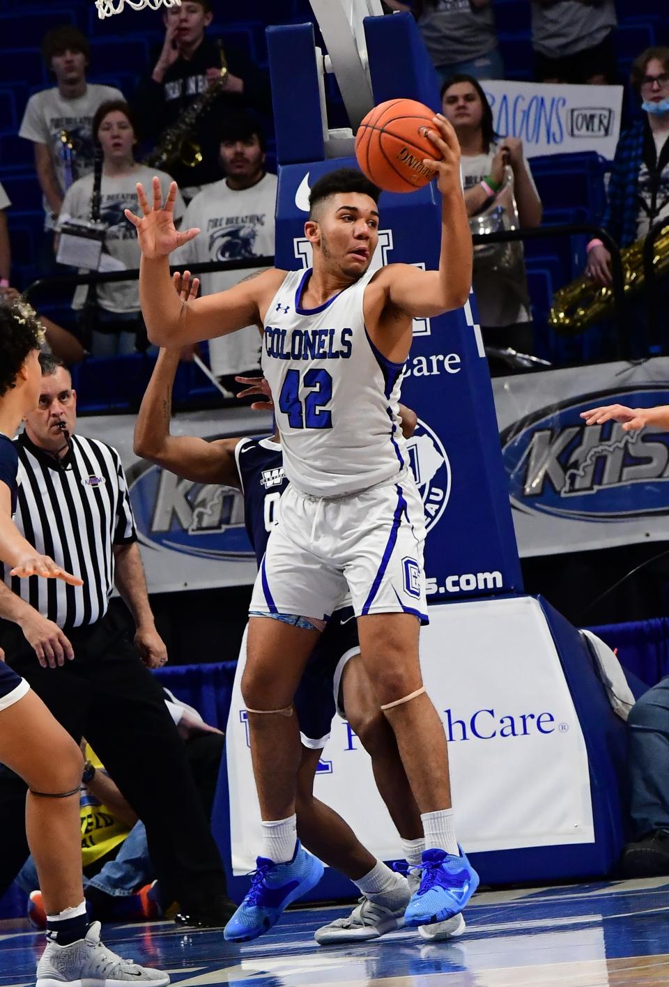 Chandler Starks grabs a defensive rebound for the Colonels in the boys basketball KHSAA state Final Four semifinal at Rupp Arena, March 19, 2022. Starks has since transferred to Anderson High School where he will return to football while also playing basketball.