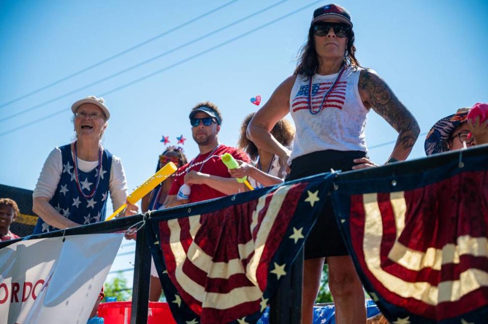 Riders of the Rancho Cordova Area Chamber of Commerce float enjoy the crowd during the city’s Fourth of July parade on Coloma Road on Thursday, July 4, 2024.