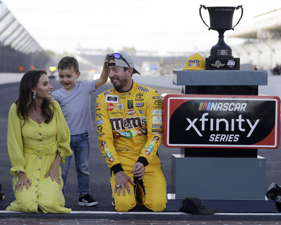 FILE - In this Sept. 7, 2019, file photo, NASCAR Xfinity Series driver Kyle Busch, right, celebrates with his wife, Samantha, and son, Brexton, after winning a NASCAR Xfinity auto race at Indianapolis Motor Speedway in Indianapolis. The Busch family hobby came full circle at Las Vegas Motor Speedway, where Kurt Busch finally won for the first time in his career Sunday, Sept. 27, 2020. The victory came about 24 hours after his nephew, Brexton, won his first race at a track in North Carolina. The 5-year-old son of reigning Cup champion Kyle is being developed by Tom Busch, who molded his own two sons into NASCAR champions. (AP Photo/Darron Cummings, File)