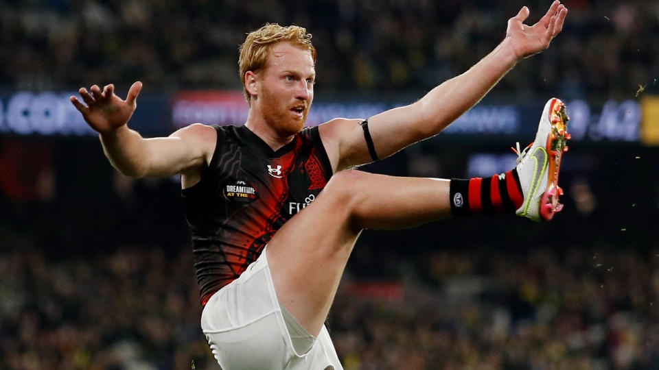 Aaron Francis takes a shot on goal for Essendon.