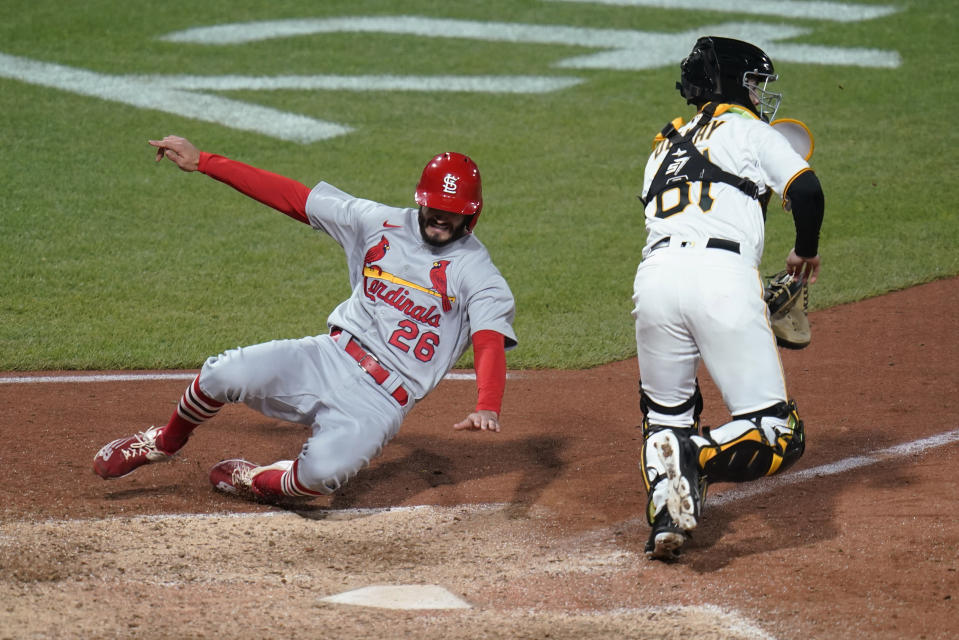 St. Louis Cardinals' Ben DeLuzio (26) scores next to Pittsburgh Pirates catcher Jason Delay on a hit by Juan Yepez during the 10th inning of a baseball game Tuesday, Oct. 4, 2022, in Pittsburgh. The Cardinals won 8-7 in 10 innings. (AP Photo/Keith Srakocic)