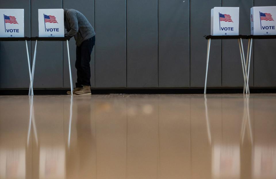 Steve Benavides, 32, of Detroit, votes inside the Cass Technical High School polling place in Detroit on Tuesday, Nov. 8, 2022. 