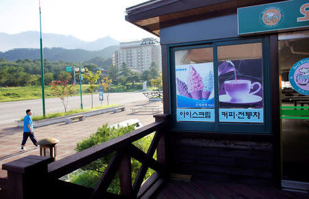 FILE PHOTO: A man walks past an empty shopping area of the Mount Kumgang resort in Kumgang August 31, 2011. REUTERS/Carlos Barria/File Photo