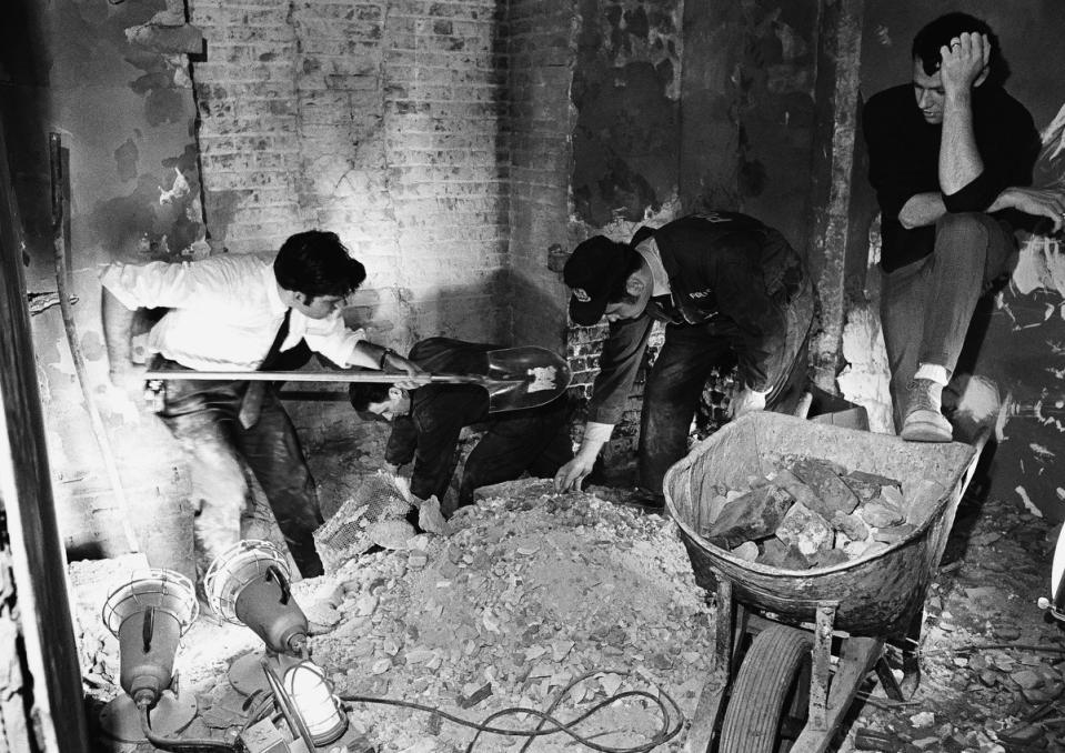 Law enforcement sift through debris in a rest room on the Senate side of the Capitol on March 1, 1971, after a bomb exploded in the area.