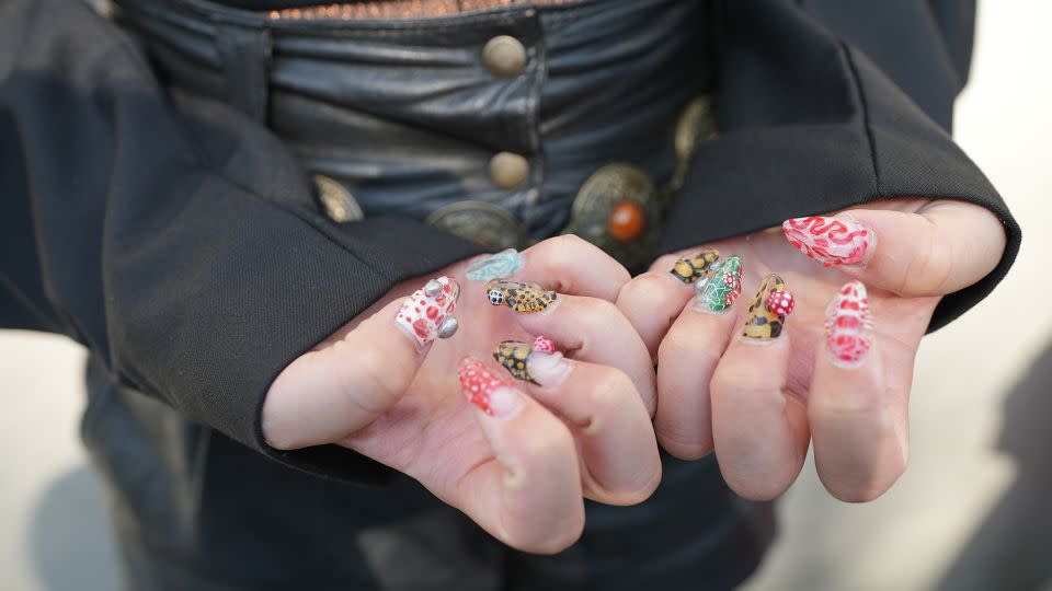 Attendee Natsumi Maso shows off elaborate nail art. - Moeri Karasawa/CNN