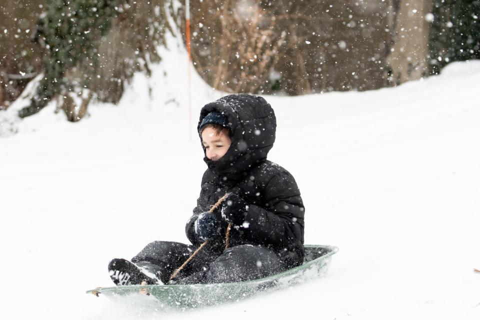 Seth Russo, 7, of Doylestown Borough, sleds down a hill outside Mercer Museum in Doylestown Borough, during a winter storm that impacted the region on Friday, January 19, 2024.