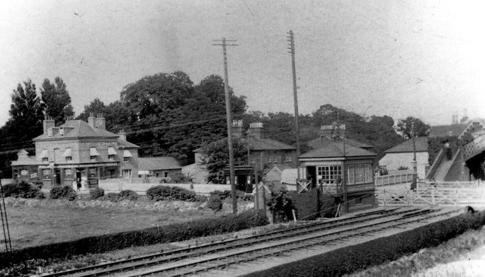 Cosham railway station approach in LBSC Railway days.. Very little remains to be seen today from this picture. The gates are now barriers and the signal box has  gone into history as well.The Railway pub is now a block of flats and the goods yard is now covered in houses. Only the footbridge remains.Even the photo cannot be retaken owing to a large block of flats being built in Portsmouth Road where the photographer was standing. (Photo: The News archive)