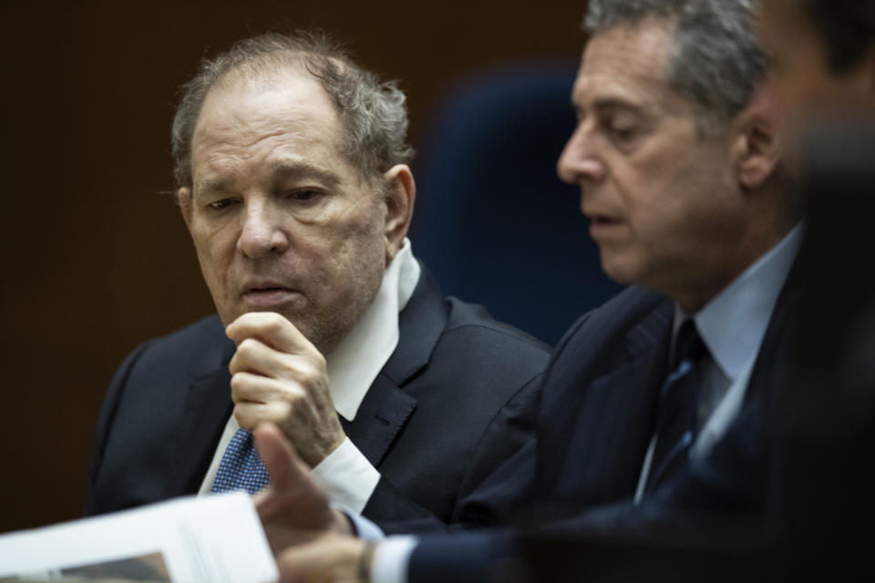 Former film producer Harvey Weinstein, left, interacts with his attorney Mark Werksman in court at the Clara Shortridge Foltz Criminal Justice Center in Los Angeles, Calif., on Tuesday, Oct. 4 2022. (Etienne Laurent/Pool Photo via AP)