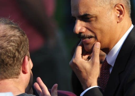 US Attorney General Eric Holder chats with a guest as he arrives for the annual picnic for Members of Congress June 27. The US Justice Department said it would not prosecute Holder over his refusal to hand over documents on a botched gun-running operation to Congress, even after the House of Representatives held him in contempt