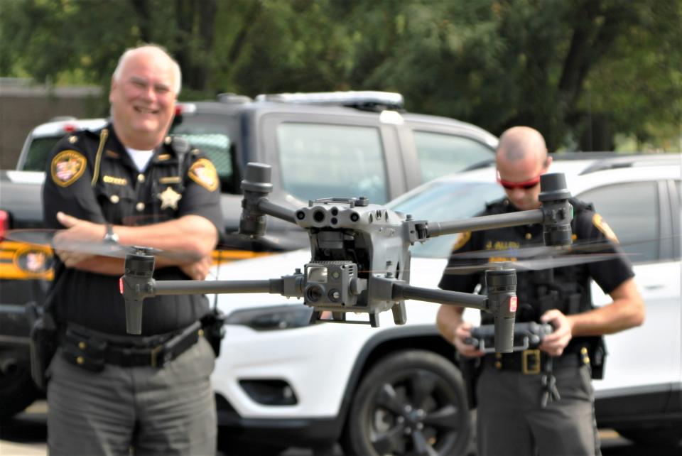 Deputy Jesse Allen, left, of the Marion County Sheriff's Office pilots a DJI drone owned by the sheriff's office. Marion County Sheriff Matt Bayles, right, said the drone is a valuable tool for his agency.