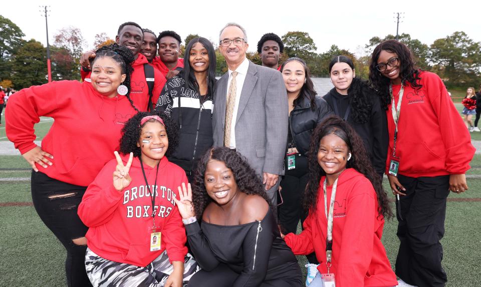 Interim Principal José Duarte poses with students during Brockton High School's Class of 2024 yearbook photo at Rocky Marciano Stadium on Friday, Oct, 20, 2023.