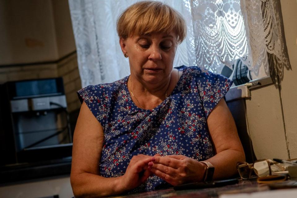 Izabela Sajbor’s mother Barbara Zientek sits in her home in Cwiklice, Poland, on July 31. Zientek was in a severe car accident in 2019 and must exercise daily for therapy. “I was in a coma for a month, Iza helped me in the hospital and then at home because I couldn't walk. She motivated me. I did everything for her. Thanks to Iza, I am alive and walking. Now that she is gone, my life has lost its meaning.”<span class="copyright">Kasia Strek for TIME</span>