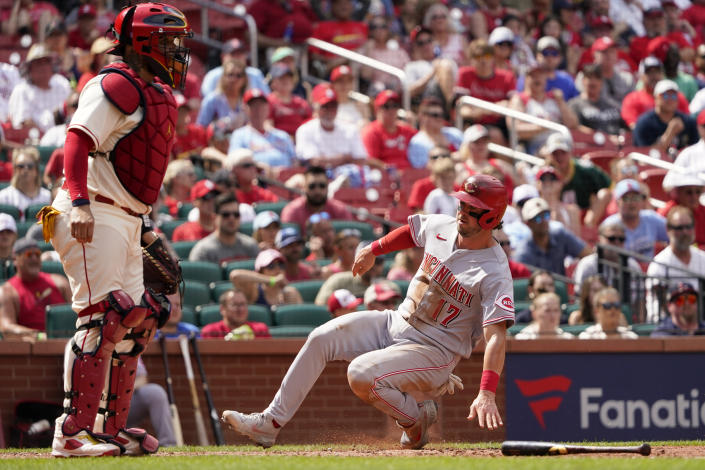 Cincinnati Reds' Kyle Farmer (17) scores past St. Louis Cardinals catcher Yadier Molina during the eighth inning of a baseball game Saturday, June 11, 2022, in St. Louis. (AP Photo/Jeff Roberson)