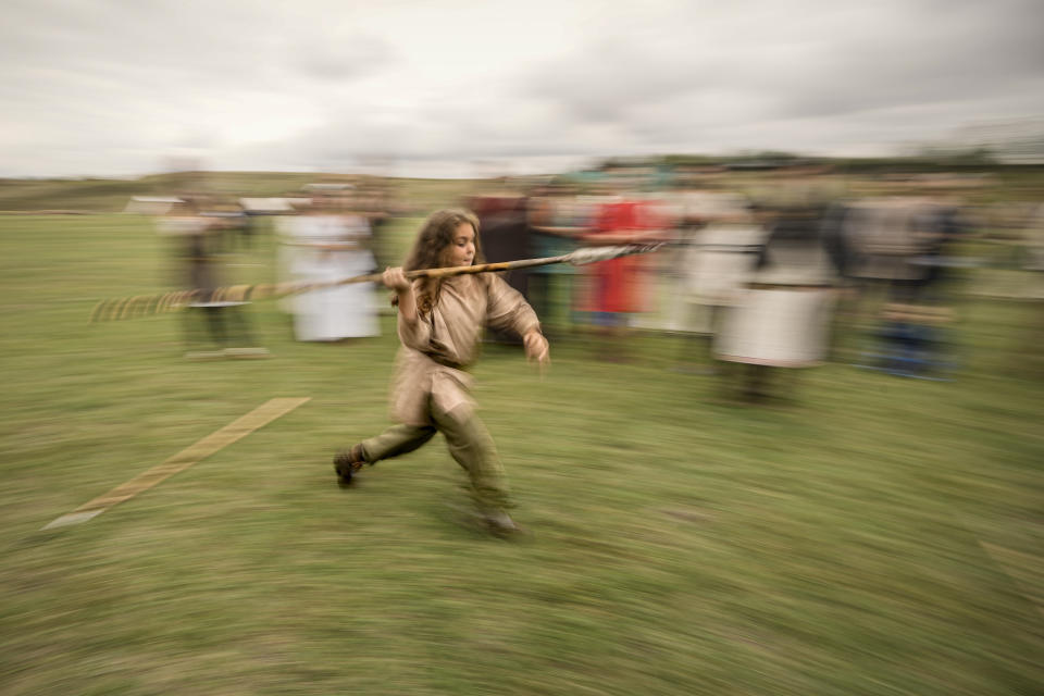 A child throws a spear during an ancient sports competition during the Romula Fest historic reenactment festival in the village of Resca, Romania, Saturday, Sept. 3, 2022. (AP Photo/Andreea Alexandru)