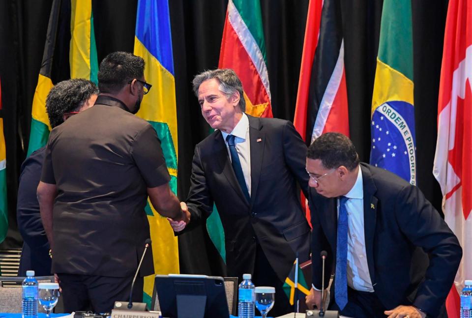 PHOTO: Secretary of State Antony Blinken, center, shakes hands with Guyana's President Irfaan Ali, next to Jamaica's Prime Minister Andrew Holness, right, during an emergency meeting on Haiti in Kingston, Jamaica, on Monday, March 11, 2024.  (Collin Reid/AP)