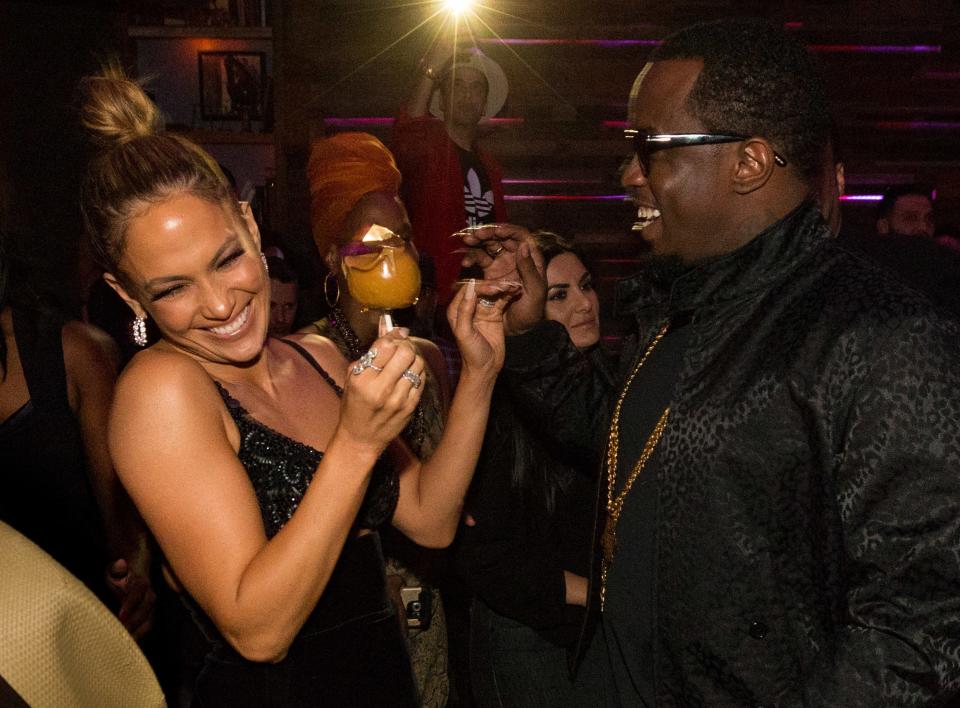 Jennifer laughs while Diddy stands across from her at a recent event