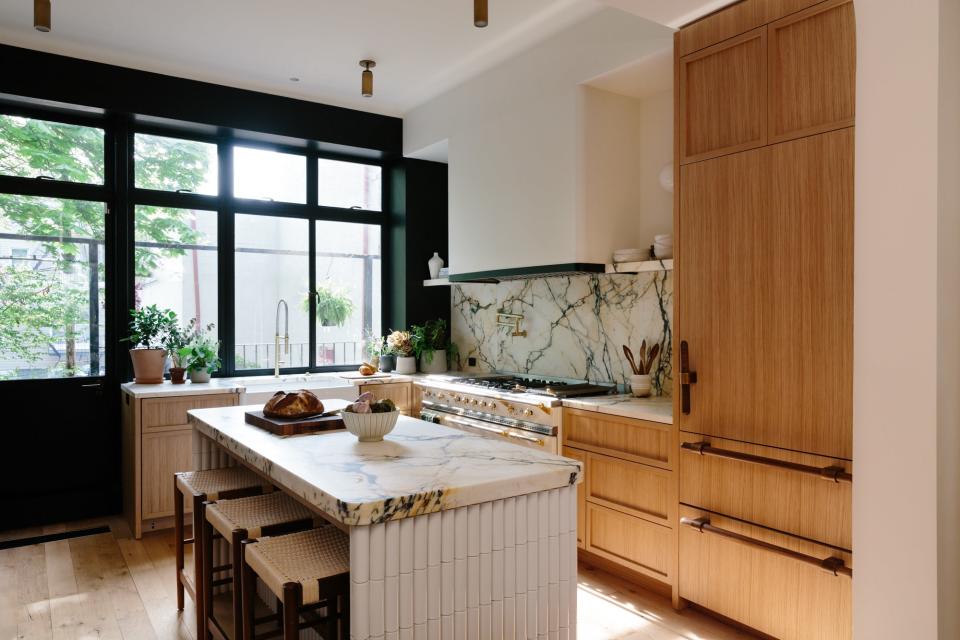 Elegant flush-mount lighting elevates this kitchen designed by Home Studios.