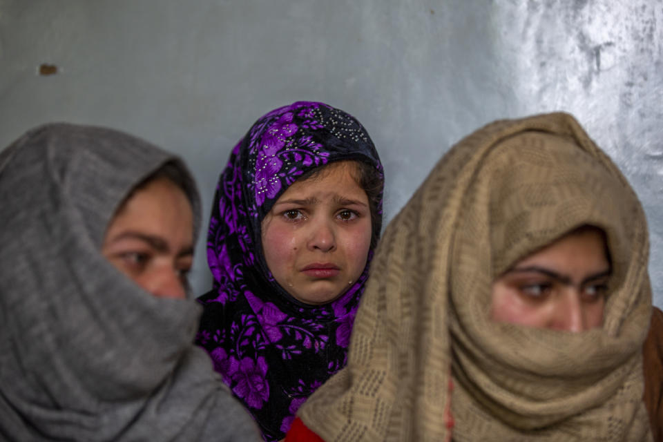 Tears roll down the cheeks of 7 year old Mahira Nazir, cousin of 16-year-old Athar Mushtaq, as the family talks to Associated Press in Bellow, south of Srinagar, Indian controlled Kashmir, Tuesday, Jan. 5, 2021. On the last week of 2020, Indian government forces killed Athar and two other young men during a controversial gunfight on the outskirts of the Indian-controlled Kashmir’s main city. Police did not call them anti-India militants but “hardcore associates of terrorists." They later buried them at a graveyard in a remote mountainous tourist resort miles away from their ancestral villages. Athar was the latest Kashmiri to be buried in a far-off graveyard after Indian authorities in a new controversial policy in 2020 started to consign blood-soaked bodies of scores of Kashmiri suspected rebels to unmarked graves, denying the mourning families a proper funeral and a burial. (AP Photo/ Dar Yasin)