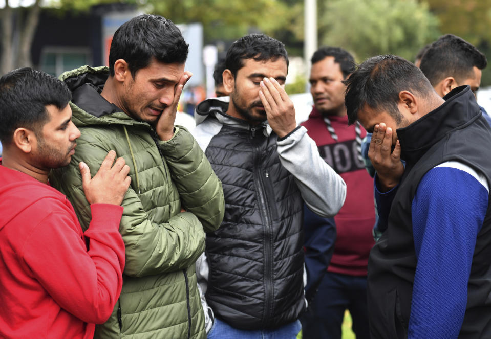Friends of a missing man grieve outside a refuge center in Christchurch, Sunday, March 17, 2019. The live-streamed attack by an immigrant-hating white nationalist killed dozens of people as they gathered for weekly prayers in Christchurch. (Mick Tsikas/AAP Image via AP)