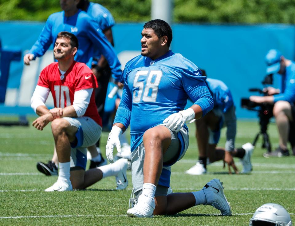 Detroit Lions offensive tackle Penei Sewell (58) warms up during organized team activities at Lions headquarters in Allen Park, Thursday, May 27, 2021.