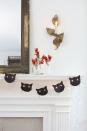<p>Young toddlers will enjoy poking the lights through the eye holes. If they're beginning to learn how to use scissors, they can practice their skills by fringing the sides of the paper cat faces.</p><p><strong>To make Cat String Lights: </strong>Download our printable <a href="http://clv.h-cdn.co/assets/cm/15/24/5578a73fa1435_-_Cat_silo.pdf" rel="nofollow noopener" target="_blank" data-ylk="slk:cat face template" class="link ">cat face template</a><em>. </em>Print and cut out the template; then use a white pencil to trace it onto black card stock and cut out desired number of faces. Fringe the sides of the cat's face and the top of its head with scissors.For each cat, cut three pieces of black waxed twine, about 4" long. Knot them together in the center of the twine, and glue to the cat's face as whiskers.Use a standard single-hole punch to create holes for eyes about 2 1/2" apart.Hang string lights and attach cat faces by pushing a light through each eye hole, spacing the faces apart at regular intervals.</p>