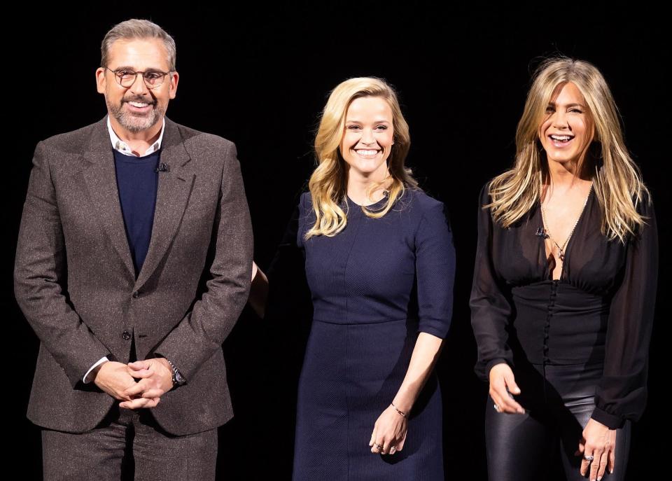 Steve, Reese and Jennifer smile on stage