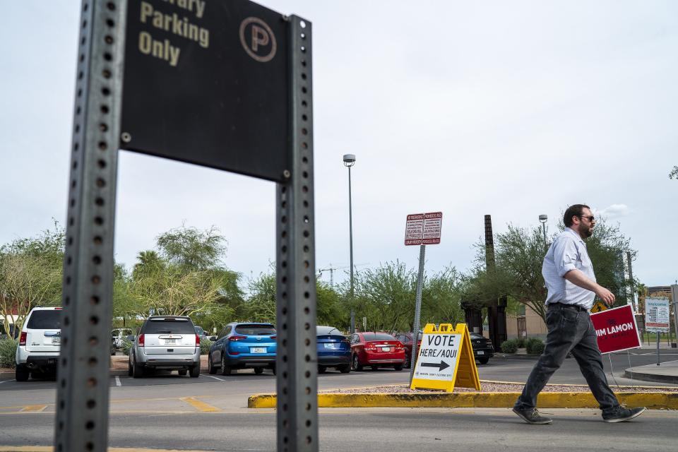 A person walks inside Burton Barr Central Library in Phoenix to vote in the Arizona primary election on Aug. 2, 2022.