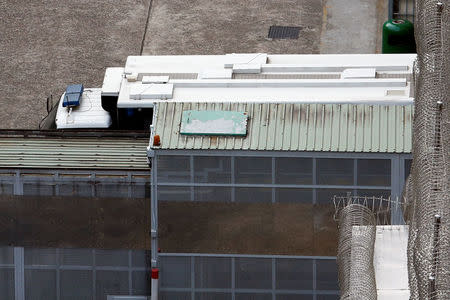 A prison van parks behind a fence to avoid British former banker Rurik Jutting, on a double murder trial, to be seen as he gets in at Lai Chi Kok Reception Centre in Hong Kong, China November 3, 2016. REUTERS/Bobby Yip