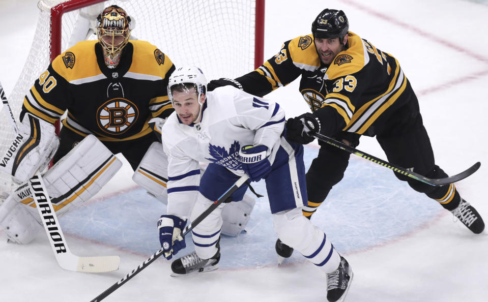 Boston Bruins defenseman Zdeno Chara (33) tries to clear Toronto Maple Leafs left wing Zach Hyman (11) away from goalie Tuukka Rask during the first period of Game 7 of an NHL hockey first-round playoff series, Tuesday, April 23, 2019, in Boston. (AP Photo/Charles Krupa)