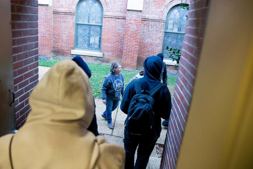 Lisa Anderson, executive director of Room In The Inn, guides guests out to their transportation for the Room In The Inn program outside First Presbyterian Church in Downtown Memphis, Tenn., on Wednesday, November 1, 2023. The guests would be transported from the home base of First Presbyterian Church to locations throughout Shelby County where churches would host them. This night, men went to a location in Germantown while women went to Christ the King Lutheran Church in East Memphis.