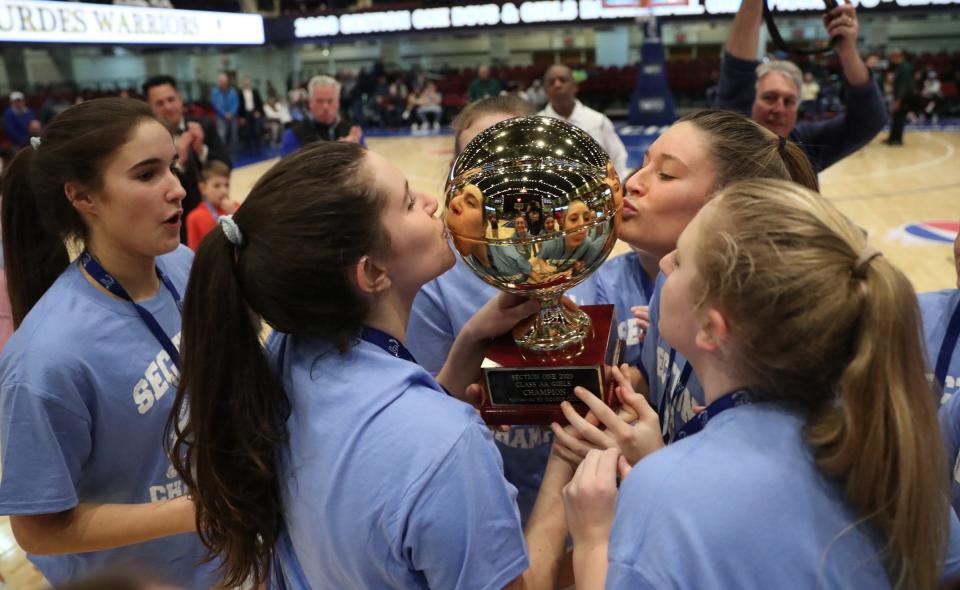 Ursuline players kiss the gold ball after defeating Lourdes 79-52 girls basketball Class AA section championship game at the Westchester County Center in White Plains on Sunday, March 8, 2020. 