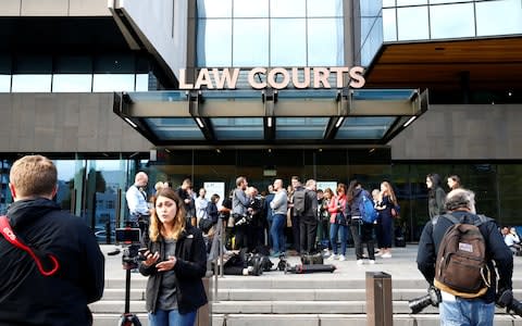 Media gathered outside the district court in Christchurch - Credit: Edgar Su/Reuters