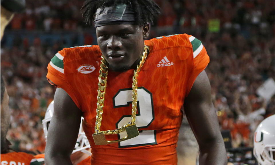 Miami defensive back Trajan Bandy wears the turnover chain after returning an interception for a touchdown during the first half of an NCAA college football game against Notre Dame, Saturday, Nov. 11, 2017, in Miami Gardens, Fla. (AP Photo/Lynne Sladky)